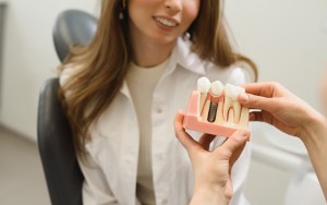 woman looking at dental implants mockup